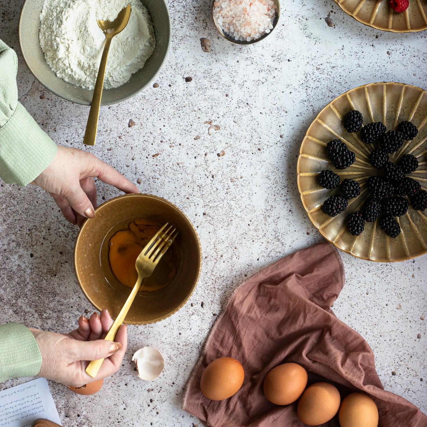 Community members collaborating in a modern kitchen space, sharing recipes and cooking techniques